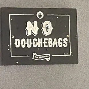 a no douchebags sign on the wall