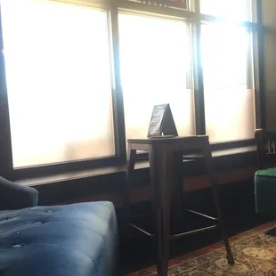 a green chair and a blue chair in front of a window