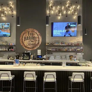 a bar with white stools