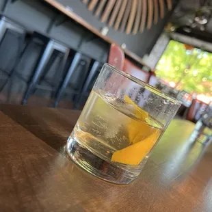 a glass of whiskey on a bar