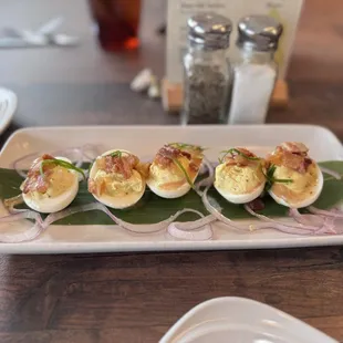Deviled Eggs. Pretty tasty, basically a deviled egg with a little bacon. I would leave off those red onions due to smell.