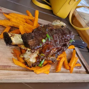 Wagyu short rib on a bed of sweet potatoes fries