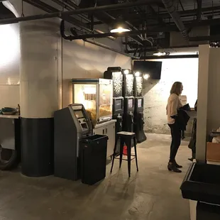 a woman standing in front of an atm machine
