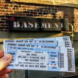 a person holding a ticket for the basement