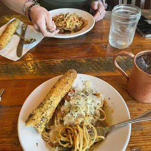 a plate of pasta and a sandwich