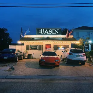 two cars parked in front of the basin