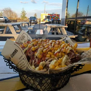 a hot dog with corn and ketchup