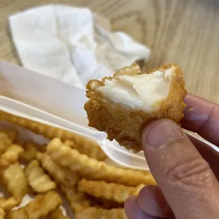 a hand holding a piece of food