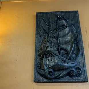 a plaque of a ship on a wall