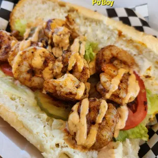 a sandwich with shrimp and lettuce