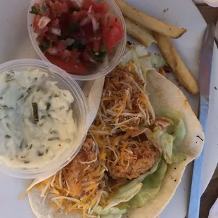 a chicken taco with a side of fries