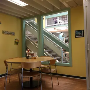 a table and chairs in front of stairs
