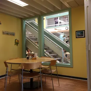 a table and chairs in front of a window