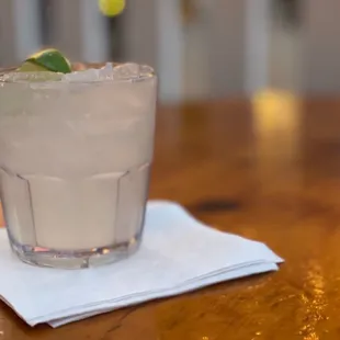 a drink in a glass on a napkin