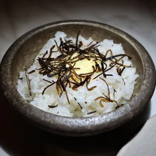 a bowl of rice with a pate of butter on top