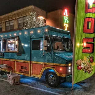 the food truck parked on the side of the road