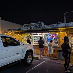 a white truck parked in front of a store