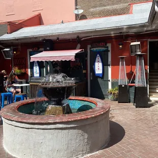 a fountain in front of a restaurant