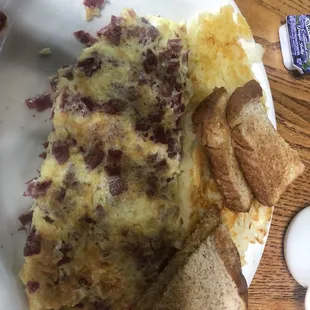 Corn beef and Swiss omelette, toast and hash browns.