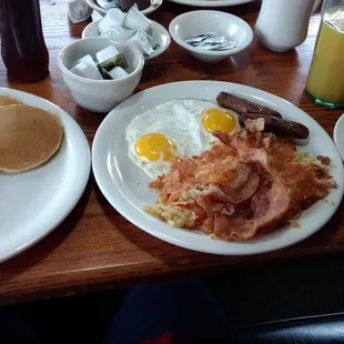 a breakfast of pancakes, eggs, bacon, and pancakes