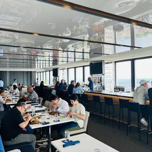 a large group of people eating in a restaurant