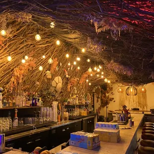 a bar with a bunch of bottles on the counter