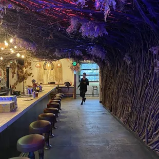 a long bar with stools in front of it