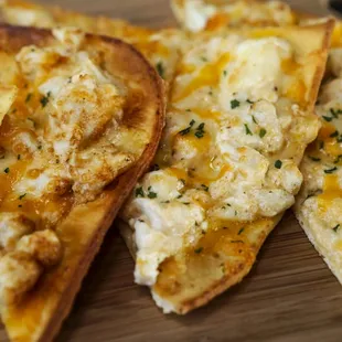 several slices of pizza on a cutting board