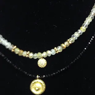 So many kinds of semi precious tiny strands with sterling vermail pendants.