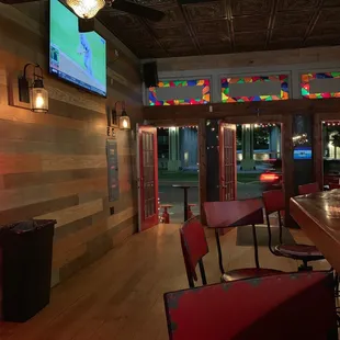 a bar with red chairs