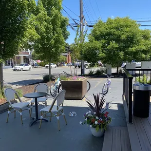 a patio area with tables and chairs