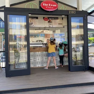 two children standing in front of a store