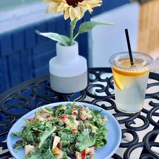 a plate of salad and a glass of lemonade