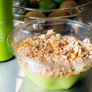 a bowl of oatmeal and a bottle of juice