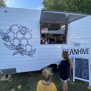 two children looking at the food truck