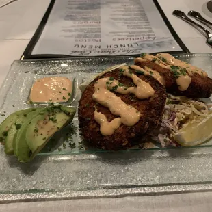 Dungeness Crab Cakes over Spicy Slaw, Remoulade Sauce and avocado