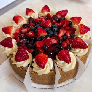 a cake with strawberries and blueberries
