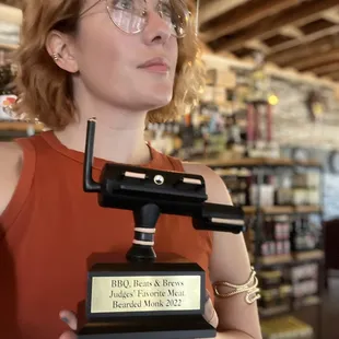 a woman holding a trophy