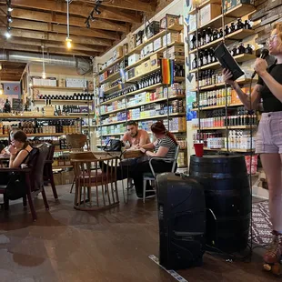 a woman standing in a wine shop