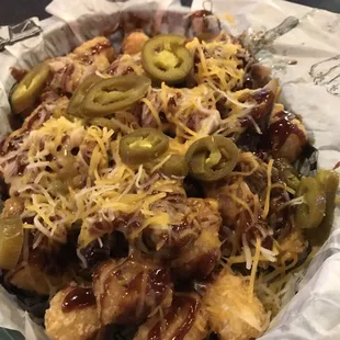 Cowboy Tots: Tots, pulled pork, BBQ, Shredded cheese and jalapeño!