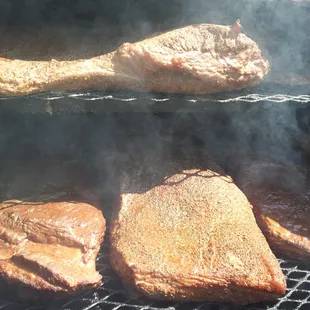 steaks cooking on the grill