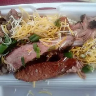 a meat and cheese sandwich in a styrofoam container