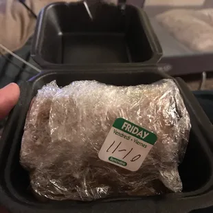 a wrap of meat in a plastic container