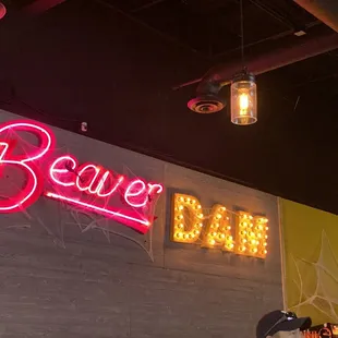 a neon sign above the bar