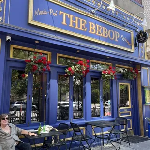 a woman sitting outside a restaurant