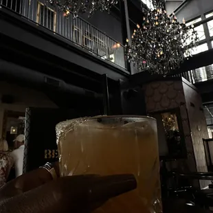 a person holding a glass of beer