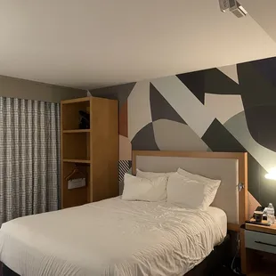 The only light source for reading in bed; a single nightstand lamp