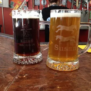 two mugs of beer on a bar