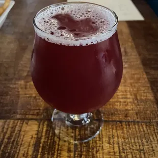 a glass of beer on a table
