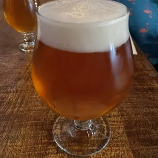 a glass of beer and a half full glass of beer